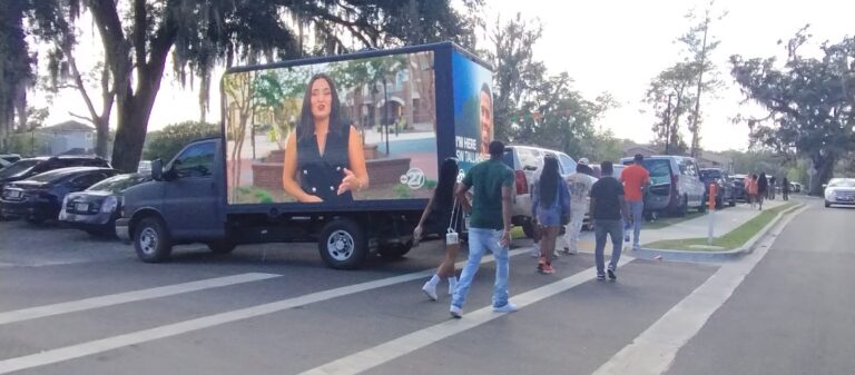 Cantmiss.US Billboard Truck broadcasts ABC Valdosta news segment in a peaceful neighborhood setting, engaging local residents.