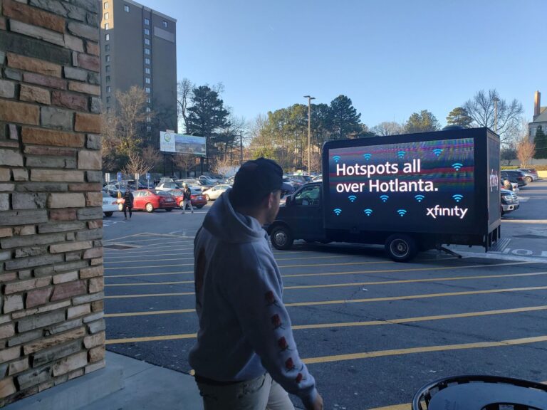 Man sees Infinity Ad on Digital Mobile Billboard Truck promoting hotspot.