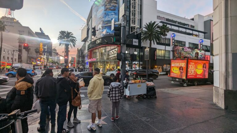 Cantmiss.US Mobile Billboard Truck displays BET Soul Awards ad at dusk in Los Angeles, surrounded by bustling city life and iconic LA scene