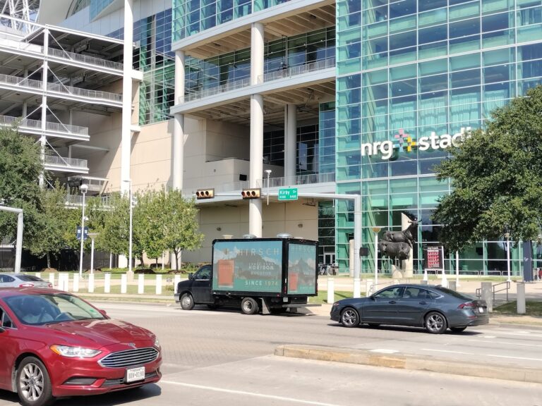 Cantmiss.US Billboard Truck with Out-of-home advertising for Hirsch outside NRG Stadium in Houston, targeting event attendees.