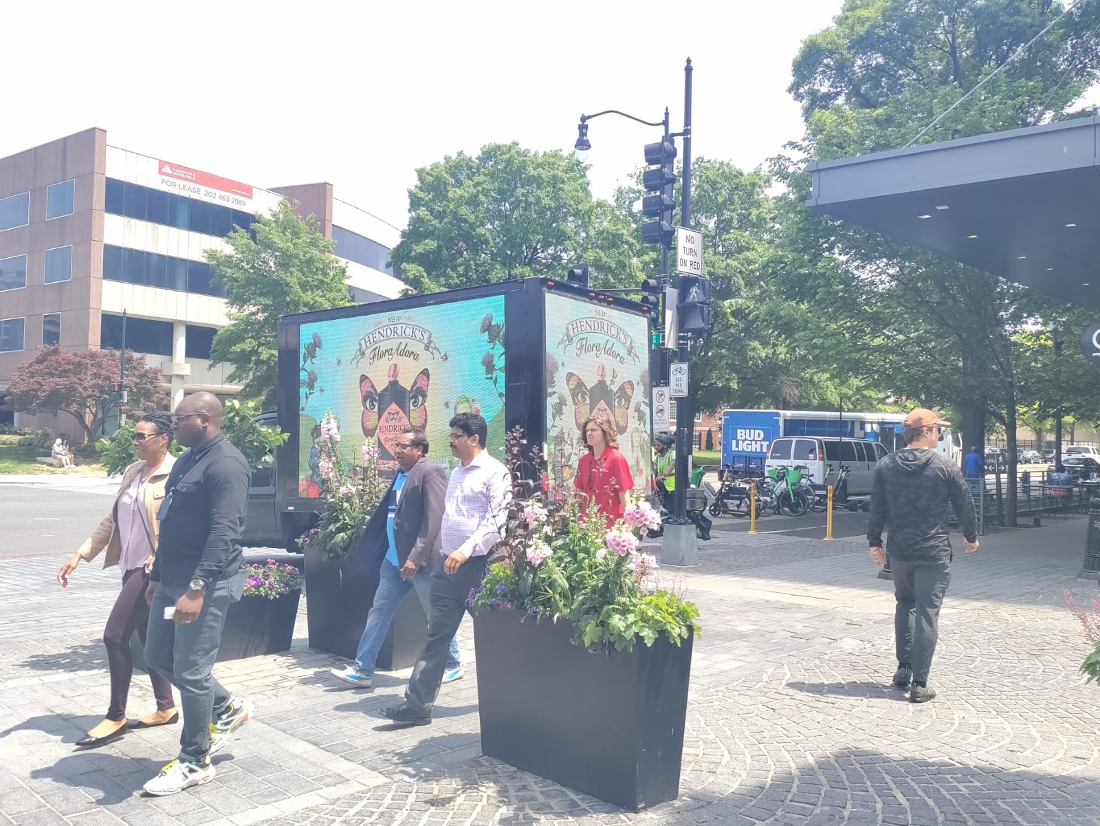 One of Cant Miss US' Digital billboard trucks showcase Hendrick's Gin advertisement, with bustling pedestrians on Washington streets.