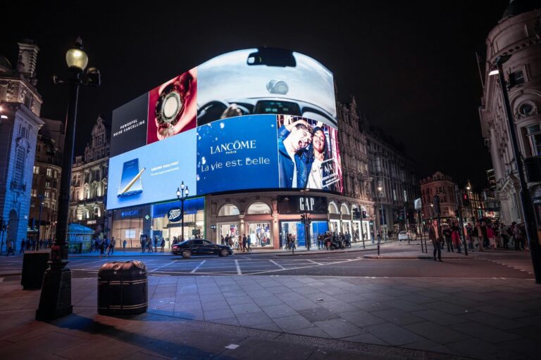 Large digital billboard at Piccadilly Circus in London displaying a variety of ads for Samsung, Lancôme, Armani Exchange and etc.
