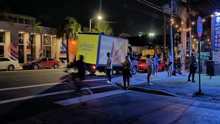LED Screen Truck Rental at night promoting Cîroc Limonata on a city street. Several people are seen to be passing by the truck.